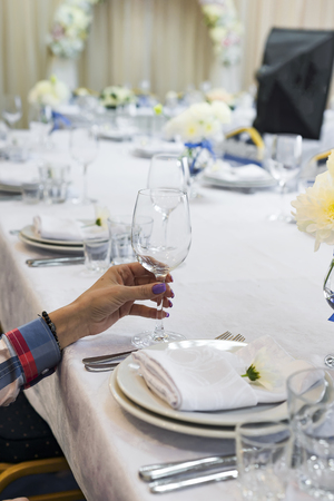 the woman is holding a glass in her handの写真素材