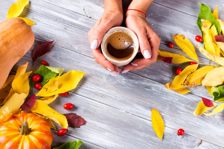 Woman holding in hands hot coffee