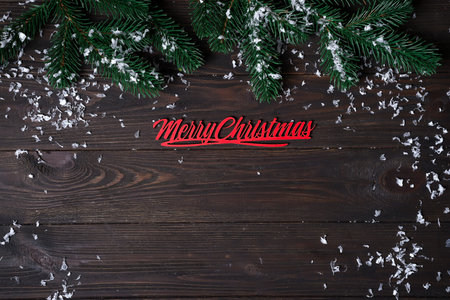 Christmas wooden background with snow fir tree. View with copy space