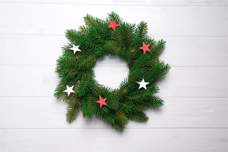 Christmas wreath with wooden stars as christmas decoration on a white wooden background, flat lay copy spaceの写真素材