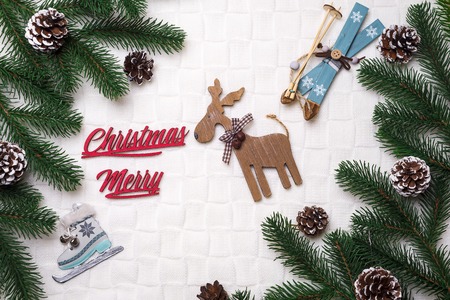 Frame Christmas cozy background with spruce branches, cones, christmas toys and branches. Merry Christmas lettering . Top view. Copy spaceの写真素材