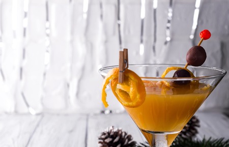 Citrus martini in a glass of New Year or Christmas on a white wooden background, a place under the textの写真素材