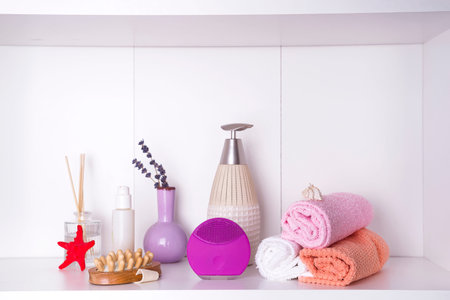 Composition with spa cosmetic, candles and brush for face, isolated on whiteの写真素材