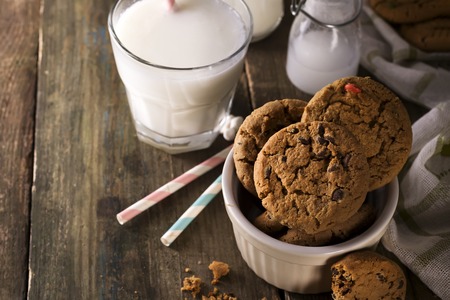 Chocolate chip cookies and milk on a rustic wood background,の写真素材