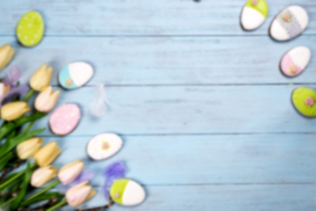 Colorful easter cookies and tulips on blue wooden backgroundの写真素材