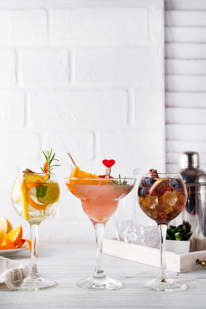 Different alcoholic drink in glass with Bar accessories on white wooden backgroundの写真素材