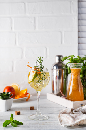 Fresh mojito drink with rosemary, lemon and orange on white wooden backgorund, copy spaceの写真素材