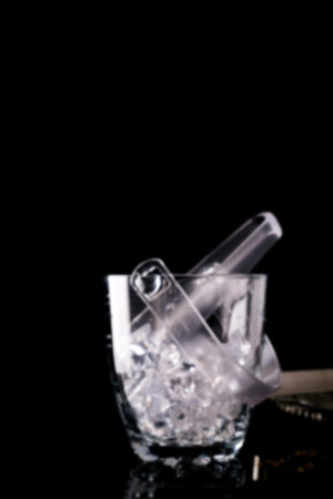 Glass ice bucket isolated on black