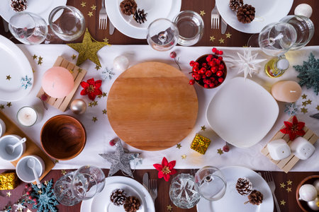 Tableware and decorations for serving a festive Christmas table. Plates, wine glasses and cutlery...