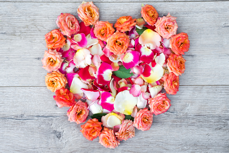 heart made of rose flowers on wooden background for Valentines day. Flat lay,の写真素材
