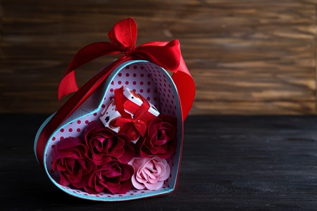 Valentines background with bouquet rose in gift box and mini gift box on dark wooden background, copy spaceの写真素材