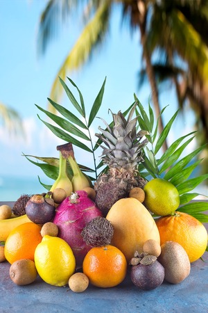 Assorted tropical fruits on the beachの写真素材