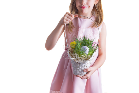 Cute little child holding basket with painted eggs on Easter day.の写真素材