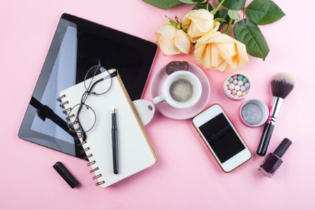 Stylized feminine flat lay with Coffee mug, roses flower, glasses and tablet mock up isolated on pink top view.の写真素材