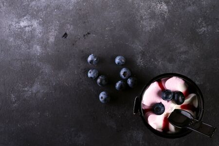 bucket of colorful ice cream with berries on a stone background, flat layの写真素材