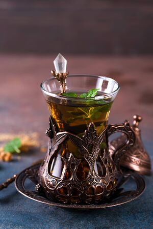 Turkish tea with mint in a traditional cups on the stone backgroundの写真素材