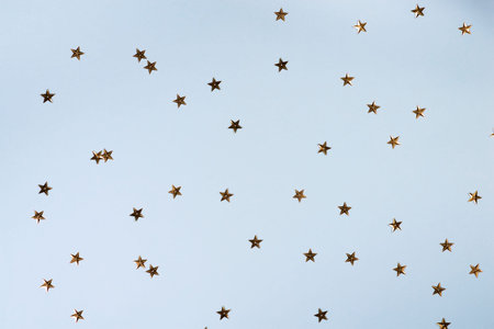 Christmas pattern made of golden stars on blue background. Christmas, Valentines or birthday...