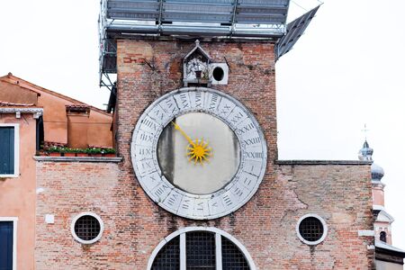 The clock of the "San Giacometto in Rialto" church located in Venice in the San Polo neighborhood closed to the famous bridge. This church is believed to be the oldest in Veniceの写真素材