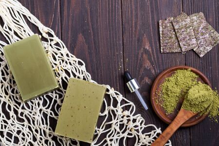 Reusable shopping bags with handmade olive soap and green powder on dark wooden background. Zero waste concept. No plastic.の写真素材