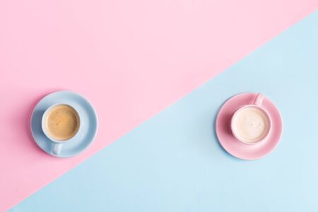 Creative pastel blue pink  with two ceramic cups of freshly brewed coffee drinkの写真素材