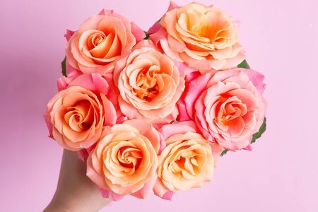 Congratulation beautiful background from freshly picked close-up roses flowers with drops of water on the petals. Top view. Natural backdrop.の写真素材