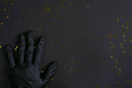 Womans hand in a black latex glove for cleaningの写真素材