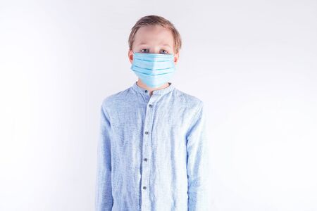 Boy in protective mask hand Covid-19, Coronavirus against light grey background.の写真素材