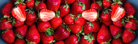 Freshly picked ripe organic natural farm strawberries with green leaves as healthy food background. Close up view. Vegan food concept.の写真素材