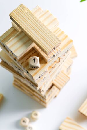 Number one cube on the top of wooden piramyd from blocks on a light grey background. game for earning, developing and education.の写真素材