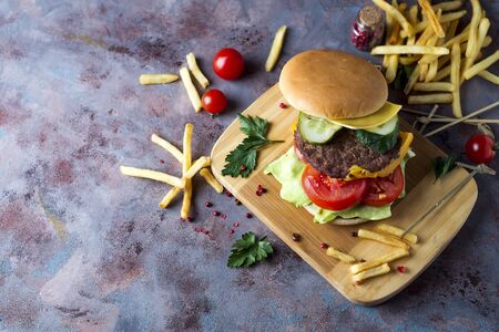 Hamburger with french fries, beer on a stone tableの写真素材