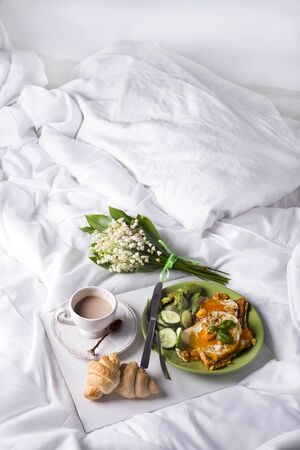 Healthy brunch poached eggs on a bed of avocado with coffee. Concept of breakfast in bed. Flat lay Copy spaceの写真素材