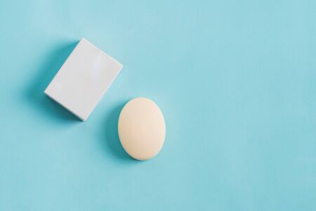 Soap wrap paper Box Mock-up package and bar soap isolated on blue backgroundの写真素材