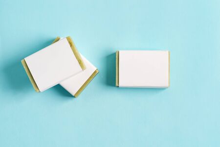 Three soap wrap box mock-up package with bar olive soap isolated on blue backgroundの写真素材