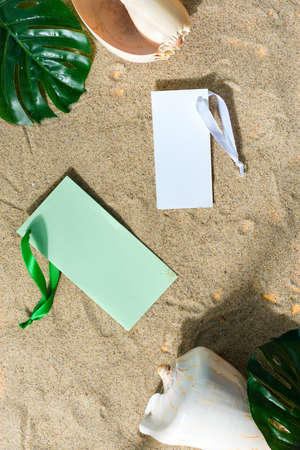 Mock up empty invitation cards on a sand beach.の写真素材