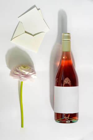 Greeting card with mockup rose wine, flower and letter.の写真素材