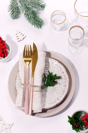 Winter festive table setting with cutlery on table. Christmas tableware.の写真素材