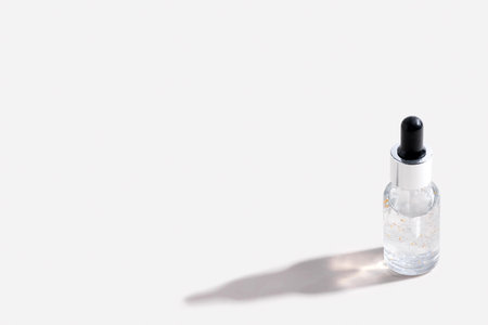 Close-up serum essence in glass bottle on white background. Isolated skincare oilの写真素材