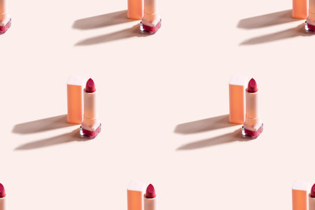 Red lipstick on beige background. Seamless pattern.の写真素材