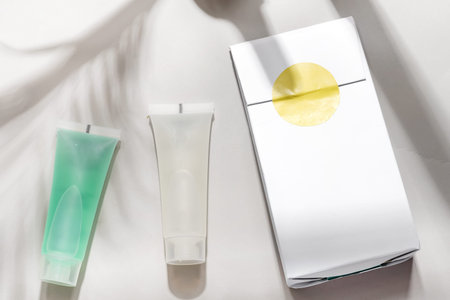 Close-up mockup tubes with pack on grey background. Isolated skincare oil