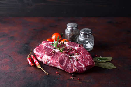 Raw steak with spices and ingredients for cooking.の写真素材
