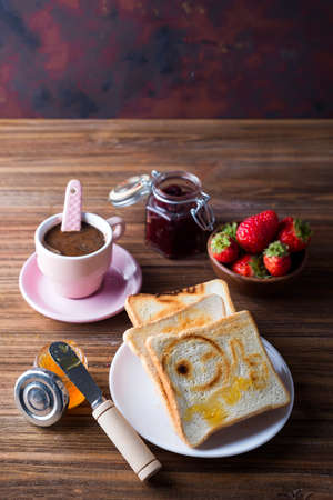 Breakfast with coffee, toasts, strawberry and jamの写真素材