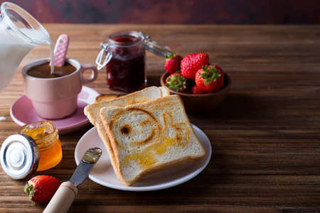 Breakfast with coffee, toasts, strawberry and jamの写真素材