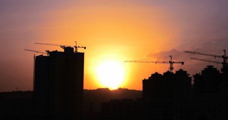 Sunset is behind the buildingの写真素材
