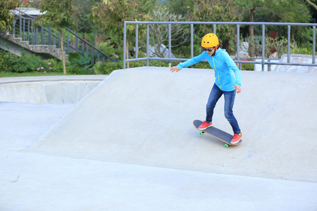 skateboarder woman skateboarding at skateparkの写真素材