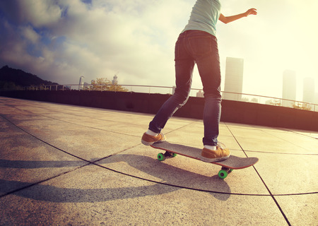 skateboarder skateboarding at cityの写真素材