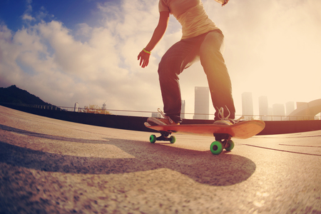 skateboarder skateboarding at  cityの写真素材