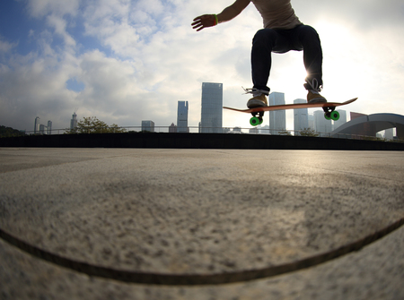 skateboarder skateboarding at sunrise cityの写真素材