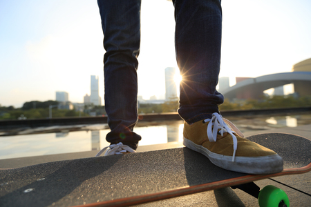 skateboarder skateboarding at  cityの写真素材