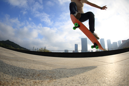 skateboarder skateboarding at  cityの写真素材