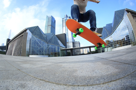 skateboarder skateboarding at  cityの写真素材